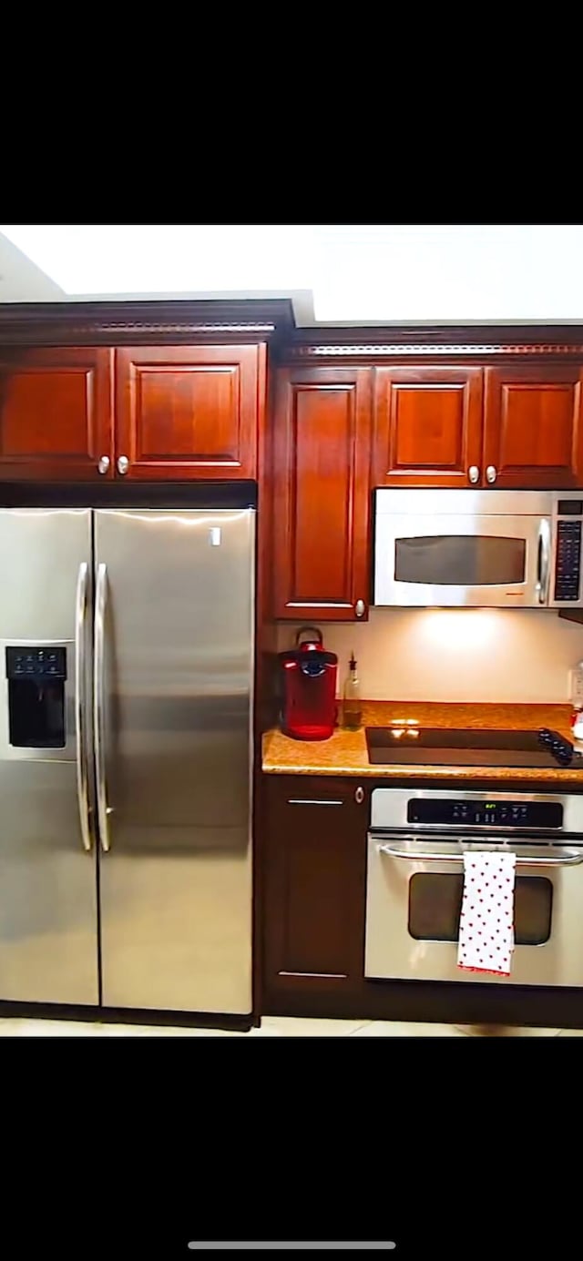 kitchen with appliances with stainless steel finishes and light countertops