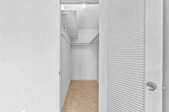 walk in closet featuring light tile patterned floors