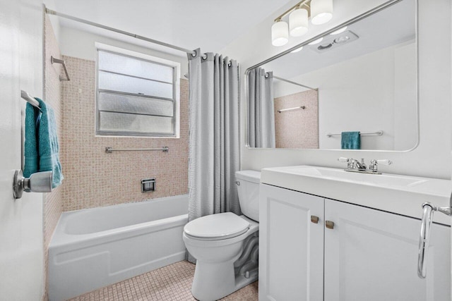 bathroom featuring vanity, tile patterned flooring, shower / bath combo with shower curtain, and toilet