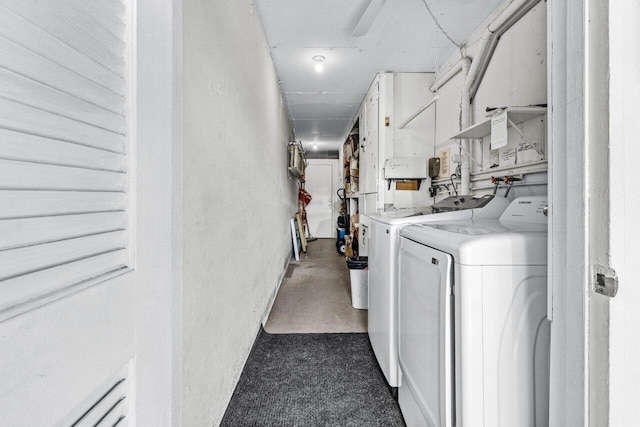 clothes washing area featuring washer and dryer and laundry area