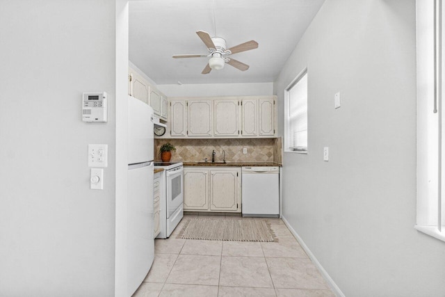 kitchen featuring light tile patterned floors, backsplash, a ceiling fan, white appliances, and baseboards