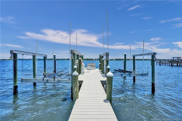 view of dock featuring a water view and boat lift