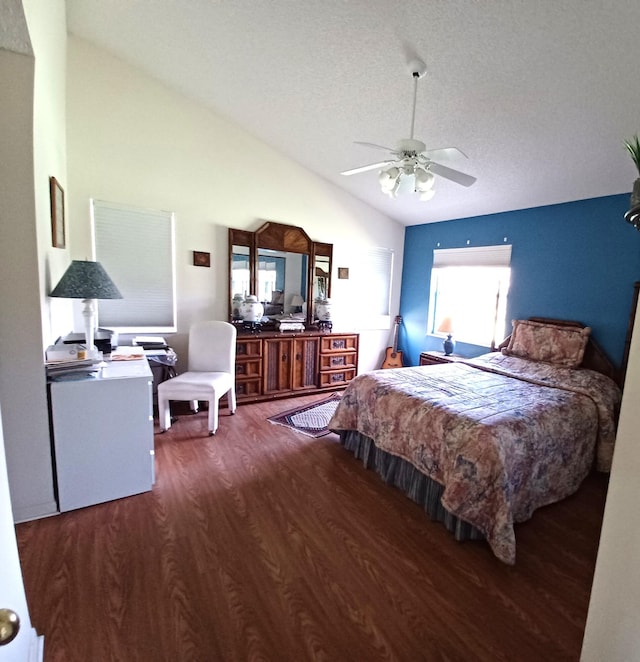 bedroom with lofted ceiling, ceiling fan, a textured ceiling, and wood finished floors