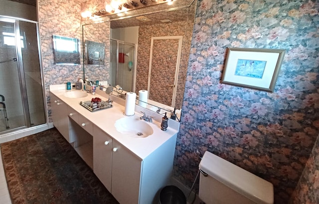 bathroom featuring wallpapered walls, a shower stall, and a sink