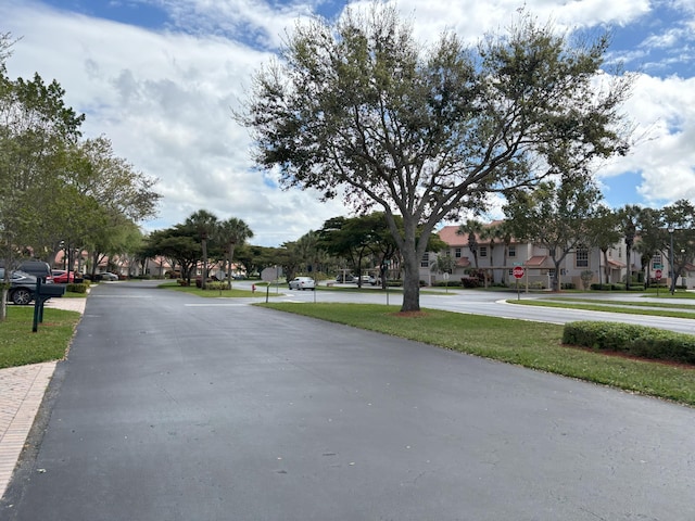 view of road featuring traffic signs and a residential view