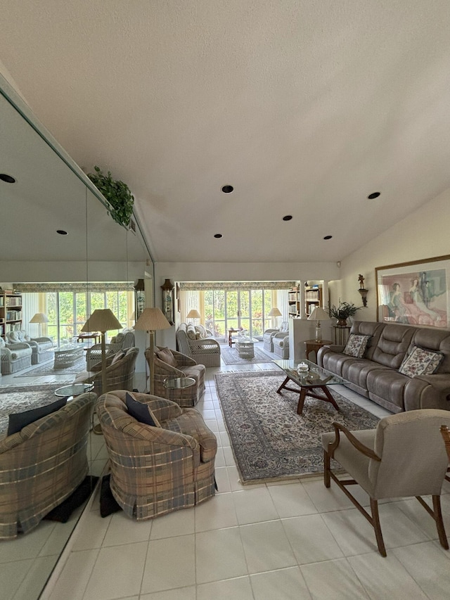 tiled living area with a healthy amount of sunlight, vaulted ceiling, and a textured ceiling