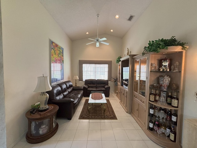 living area with ceiling fan, light tile patterned floors, recessed lighting, visible vents, and vaulted ceiling