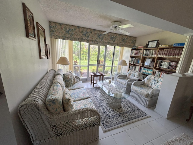 tiled living room with a textured ceiling and ceiling fan