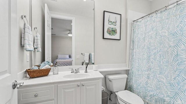 bathroom with toilet, ensuite bath, and vanity