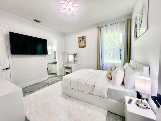 bedroom featuring marble finish floor, ensuite bath, multiple windows, and visible vents