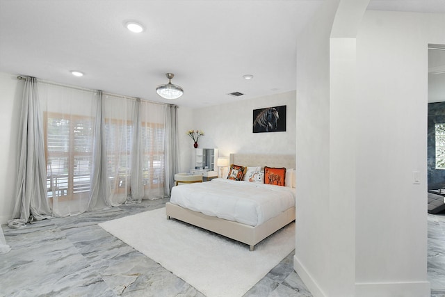 bedroom featuring arched walkways, marble finish floor, visible vents, and recessed lighting