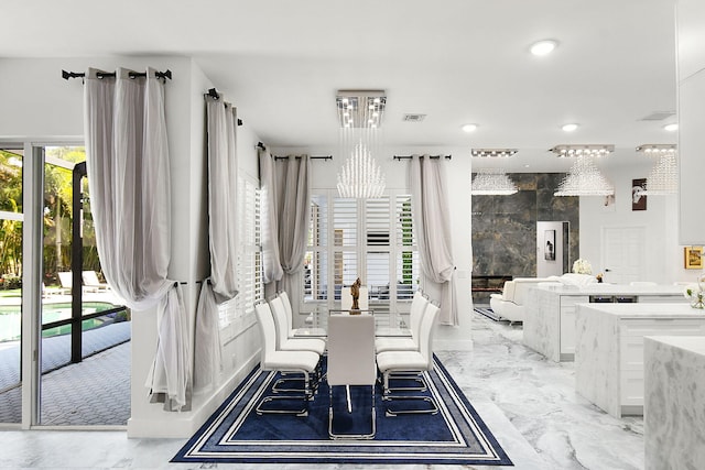 unfurnished dining area with marble finish floor, visible vents, a notable chandelier, and recessed lighting