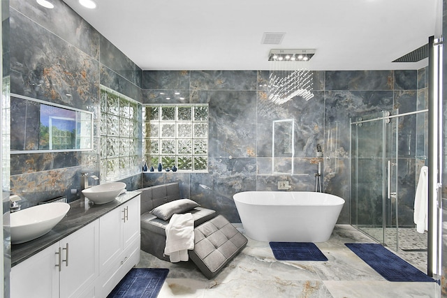 full bath featuring a shower stall, tile walls, and a sink