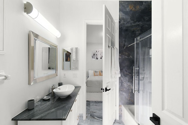 bathroom with marble finish floor, ensuite bath, and vanity