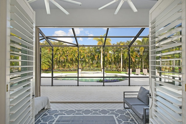 sunroom with ceiling fan and a hot tub