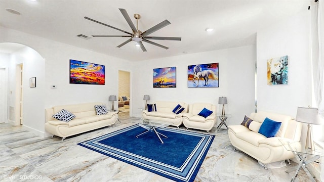 living area featuring arched walkways, a ceiling fan, visible vents, recessed lighting, and marble finish floor