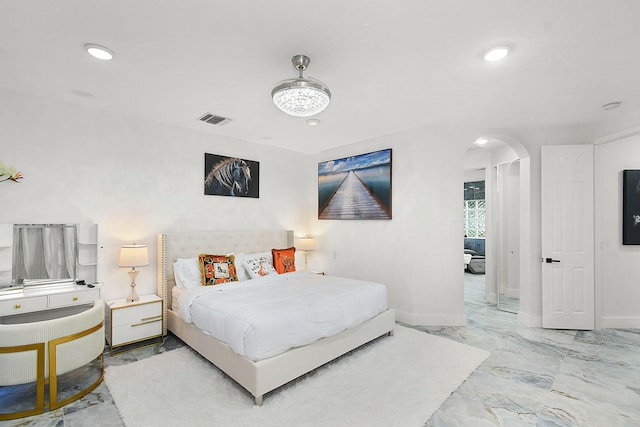 bedroom featuring baseboards, visible vents, arched walkways, marble finish floor, and recessed lighting