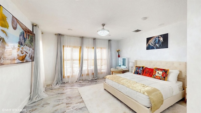bedroom with visible vents and marble finish floor