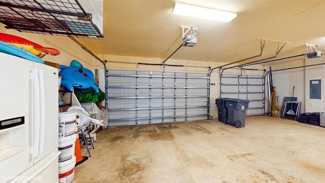 garage with electric panel, freestanding refrigerator, and a garage door opener