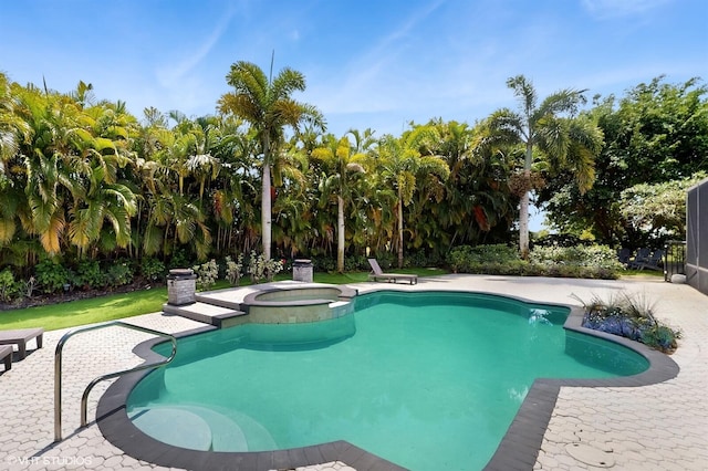 view of swimming pool with a patio area and a pool with connected hot tub