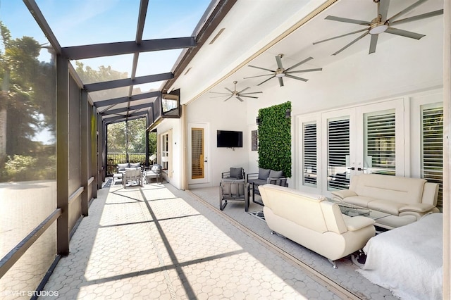 view of patio featuring visible vents, glass enclosure, an outdoor hangout area, and a ceiling fan