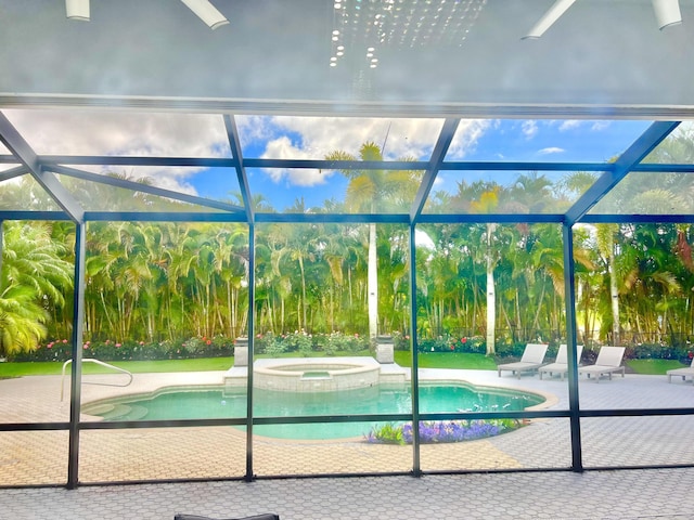 view of swimming pool with a lanai, a patio area, and a pool with connected hot tub