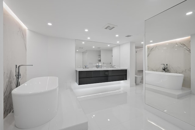 3140 S Ocean Blvd S Unit 502S, Palm Beach, FL 33480 - full bathroom featuring visible vents, double vanity, recessed lighting, a sink, and a freestanding bath