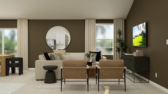 living area featuring light colored carpet and baseboards