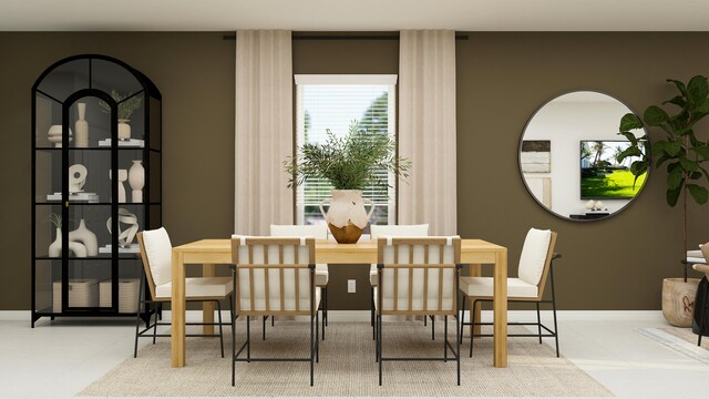 dining space featuring baseboards and tile patterned floors