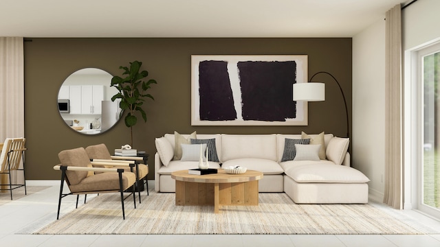 sitting room featuring a healthy amount of sunlight, baseboards, and tile patterned floors