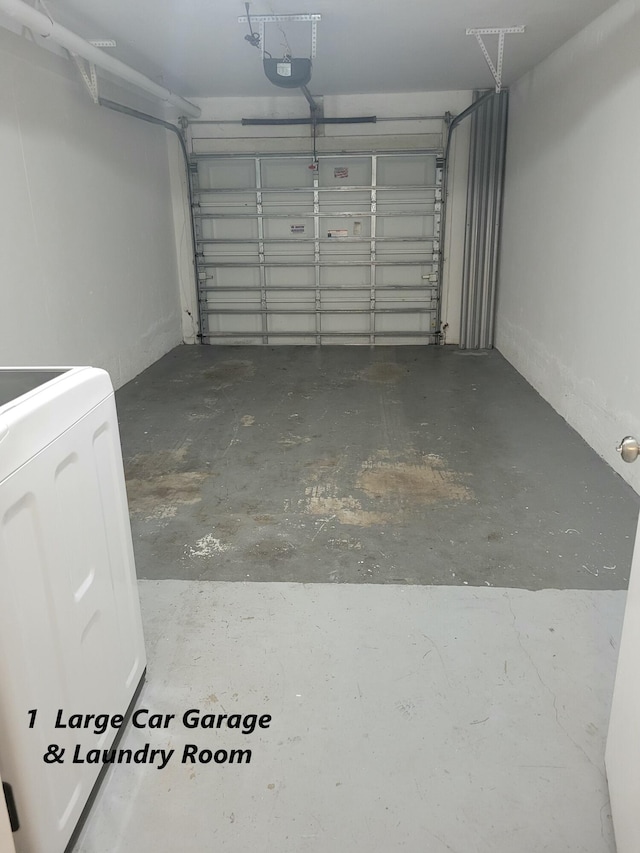 garage with a garage door opener and washer / dryer