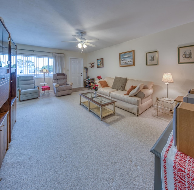 living area featuring carpet floors and a ceiling fan