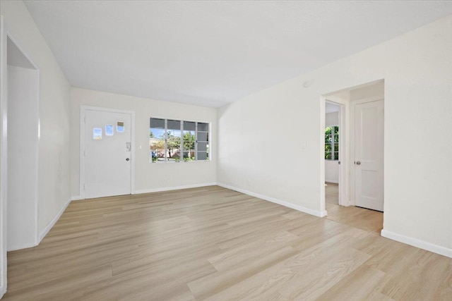 interior space featuring light wood finished floors and baseboards