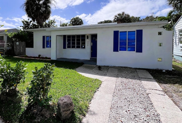 single story home with a front yard, fence, and stucco siding