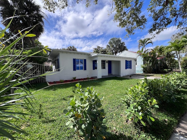 single story home featuring a front lawn and stucco siding