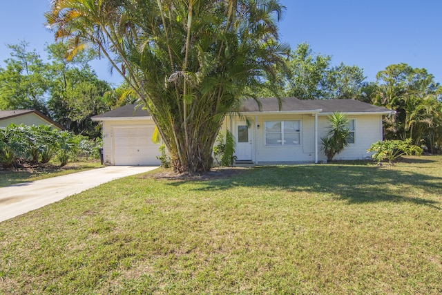 single story home featuring a front lawn, concrete driveway, and an attached garage