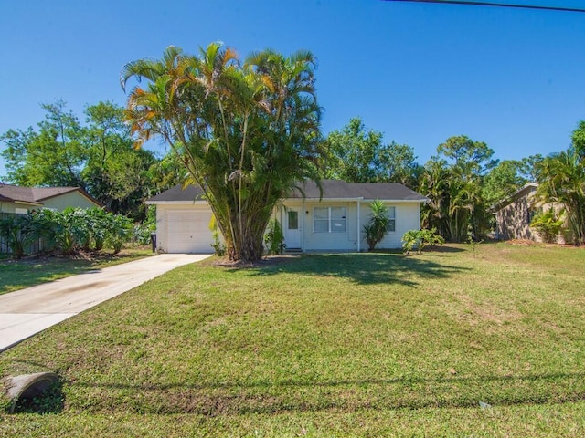 view of front of property featuring a front lawn, driveway, and an attached garage