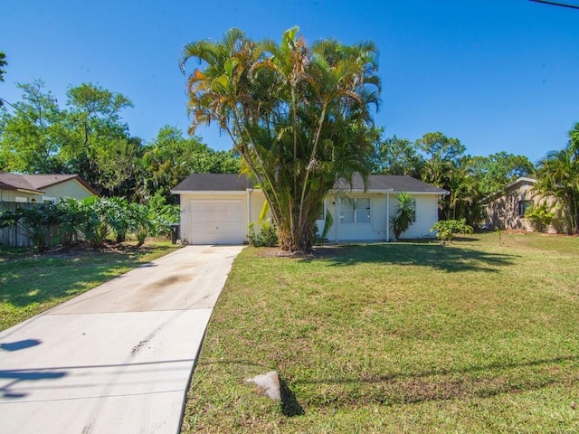 ranch-style home with concrete driveway, an attached garage, and a front lawn