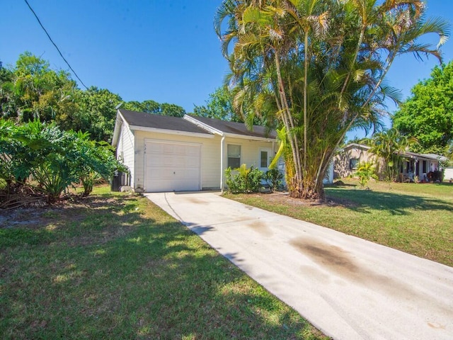 view of front facade featuring a garage, driveway, and a front lawn