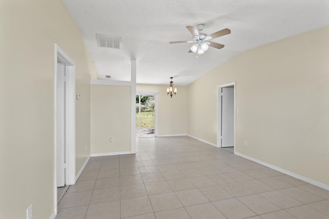 empty room featuring visible vents, lofted ceiling, ceiling fan with notable chandelier, a textured ceiling, and light tile patterned flooring