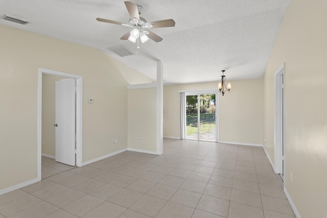 empty room with light tile patterned floors, visible vents, a textured ceiling, and ceiling fan with notable chandelier