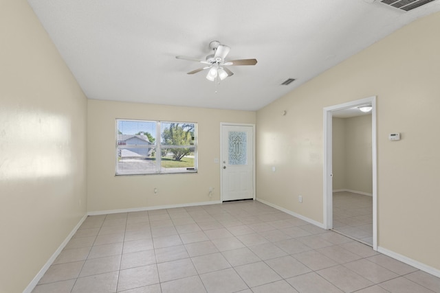 spare room with ceiling fan, light tile patterned flooring, visible vents, and baseboards