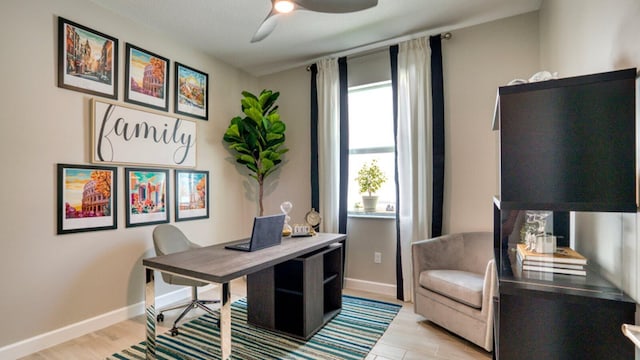 office area featuring ceiling fan, light wood-style flooring, and baseboards