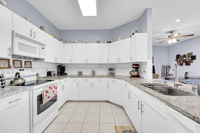 kitchen featuring white appliances, light tile patterned floors, white cabinets, a ceiling fan, and a sink