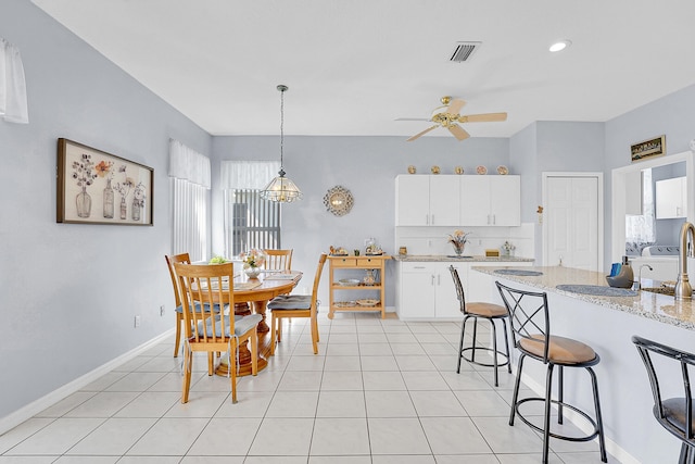 dining room featuring light tile patterned floors, baseboards, visible vents, and ceiling fan