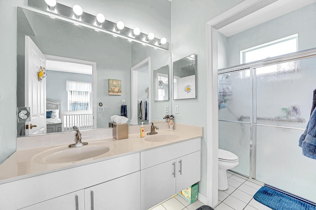 bathroom with double vanity, a sink, and a shower stall