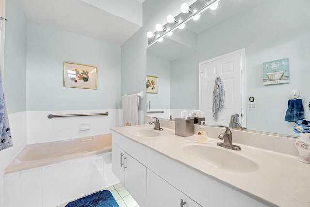 bathroom featuring a garden tub, double vanity, a sink, and tile patterned floors