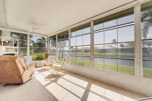 unfurnished sunroom with a water view and a ceiling fan