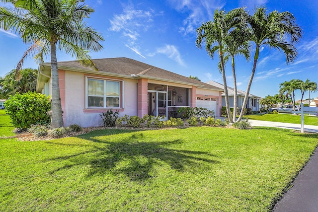 ranch-style home with a front yard, concrete driveway, an attached garage, and stucco siding