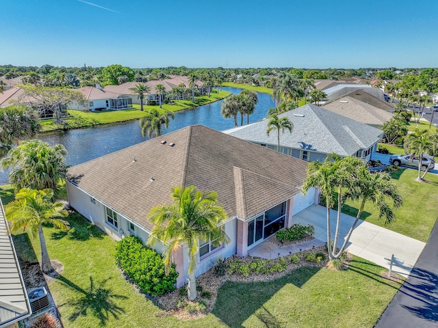 drone / aerial view with a residential view and a water view